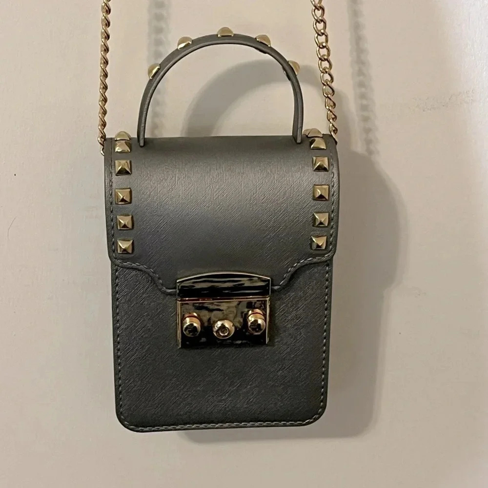 Grey crossbody with gold studs gives a sassy stylish look for a night out